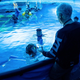 cameron talking to people in a tank